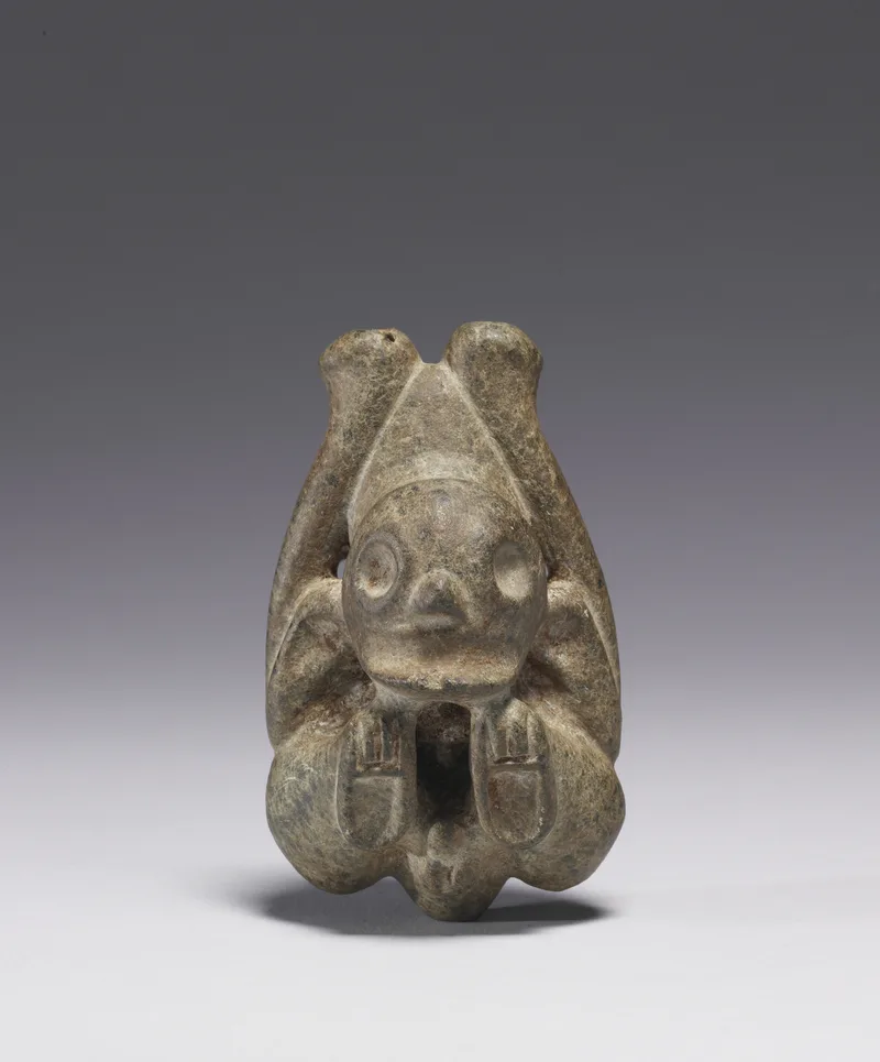 Taíno stone inhaler carved as a seated figure, with two tubes rising from the top